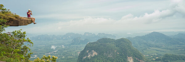  tourist - photographer taking photo at mountain peak. 