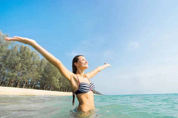 Woman into sea with raised up hands — Stock Photo, Image