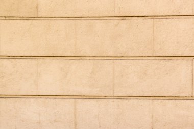 Arka plan büyük tuğla sarı beton duvar ile