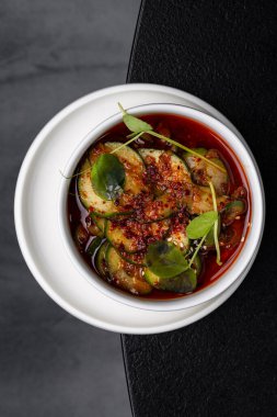 Menü için ayrılmış beyaz bir tabakta Asya soslu salatalık ve fasulye salatası.