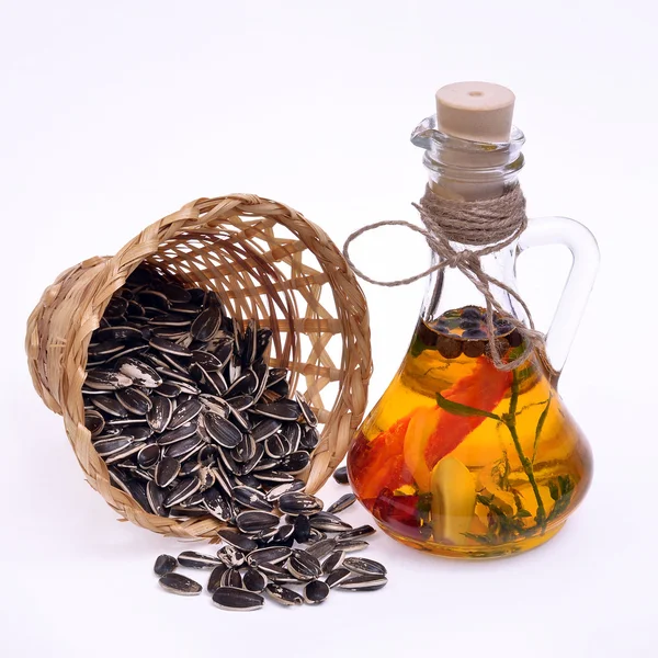 Sunflower oil with sunflower seeds on a white background — Stock Photo, Image