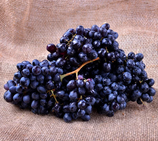 Close-up of black grapes on a brown background Stock Photo