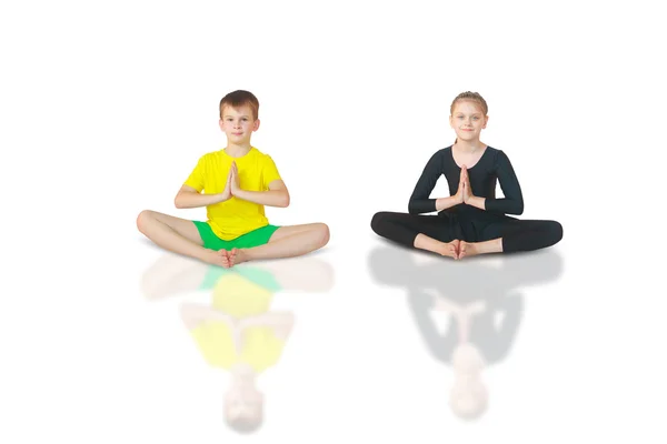 Boy and girl doing yoga on white background — Stock Photo, Image