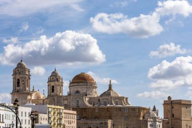 Beautiful view of a city on the Atlantic coast. A historic old town brimming with history and life. A beautiful view of the Cathedral from the waterfront promenade in Cadiz, Andalusia, Spain
