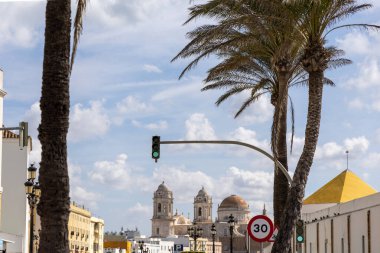 Beautiful view of a city on the Atlantic coast. A historic old town brimming with history and life. A beautiful view of the Cathedral from the waterfront promenade in Cadiz, Andalusia, Spain