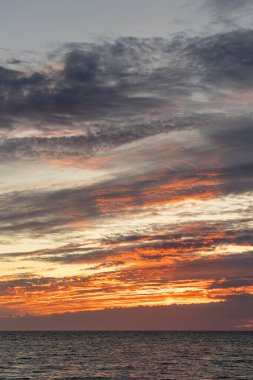 A breathtaking sunset on the beach. View of the twilight over the sea to the horizon. Landscape shot on the Atlantic coast near Rota, Costa de la Lutz, Cadiz, Andalusia, Spain.