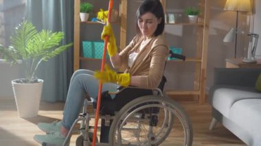 Özürlü genç bir kadının portresi daireyi temizliyor.
