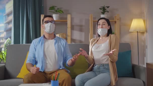 Man and woman sitting in the living room rejoice at the lifting of the quarantine slow mo — Stock Video
