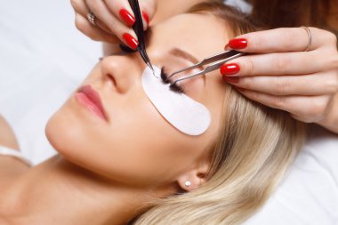 Kirpik uzatma prosedürü. Uzun kirpikli kadın gözü. Kırbaçlar, kapatın, seçili odak.