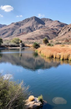 landscape with lake and mountains at the background