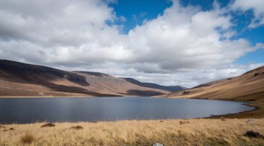 beautiful mountain lake with blue sky and clouds in the background