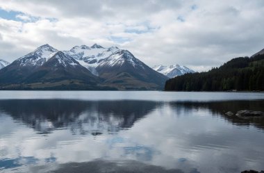 lake with reflection of mountains in cloudy weather. high quality photo