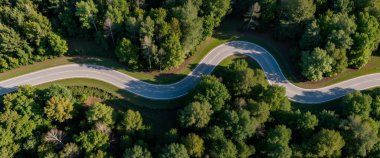 a drone shot of road in the autumn forest, finland