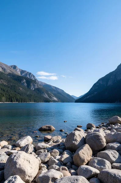 a vertical view of the beautiful lake surrounded by mountains
