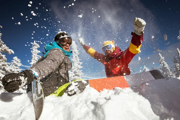 Couple of snowboarders sitting in snowdrift — Stock Photo, Image