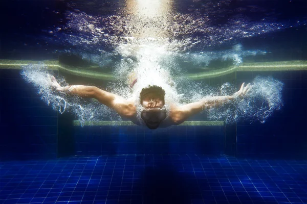 man in sunglasses underwater dives
