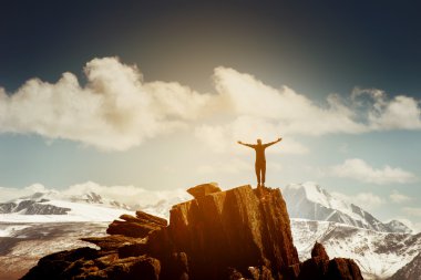 Man in winner pose with raised hands stands on the top of mountains. Win concept clipart