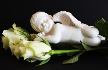 Melek heykeli ile beyaz güller