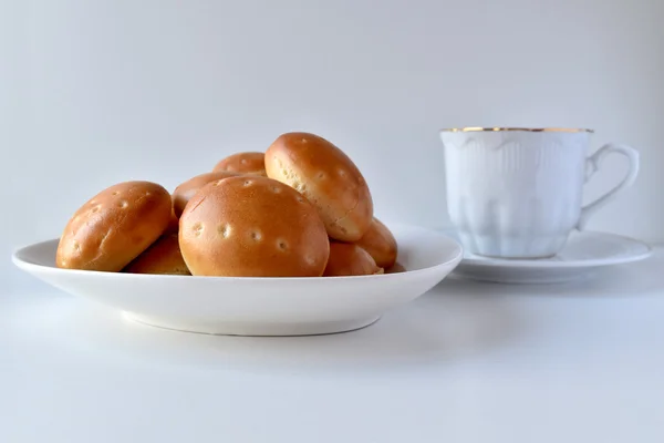 Вкусные мини булочки с чашкой кофе — стоковое фото