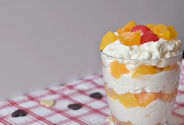 Glass of  dessert vanilla mousses with fruit on top — Stock Photo, Image