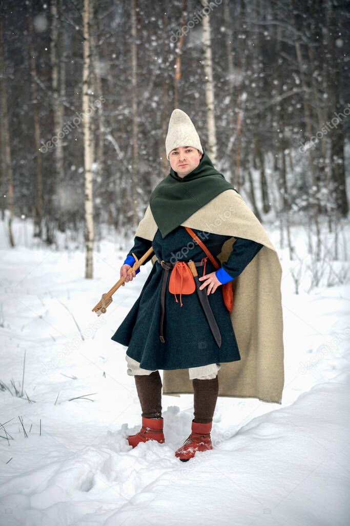 Young man in medieval European costume, historical reenactment 
