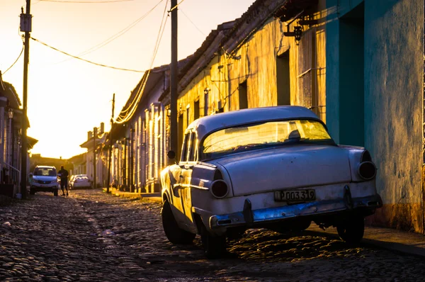 Trinidad, Cuba: Street with oldtimer at sunset