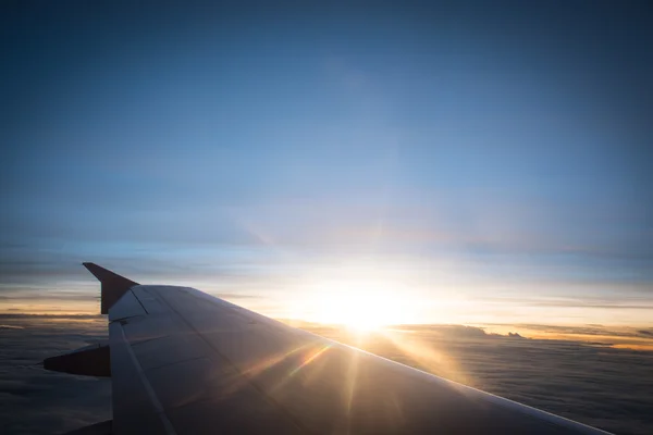 Sun rise on airplane with flare sun light.