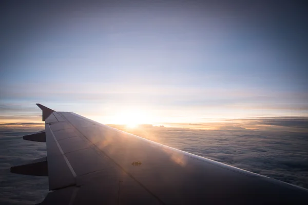 Sun rise on airplane with flare sun light.