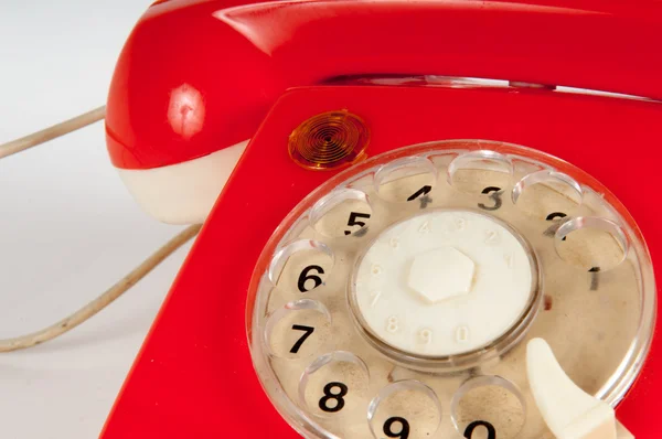 Retro orange telefon med vredet på vit — Stockfoto