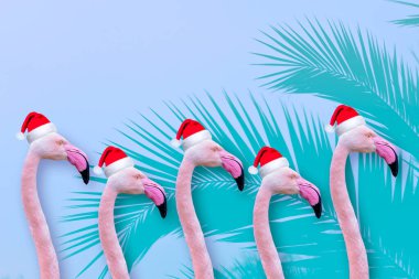 Festive flamingo Greeting or Christmas card with funny animals in xmas santa hats with space for a message