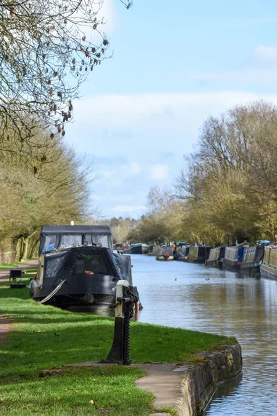 Canal boat or narrow boat moored on the bank of a canal during a sunny day