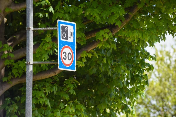 30 mph speed limit warning of traffic camera on city street