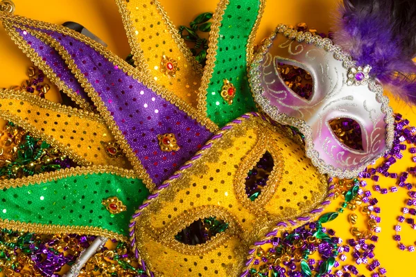 Colorido grupo de Mardi Gras o máscara veneciana o trajes sobre un fondo amarillo —  Fotos de Stock