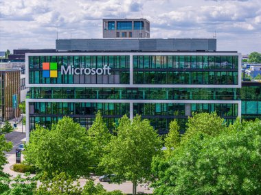 Aerial footage of the modern Microsoft headquarters in Munich, showcasing the contemporary office architecture and urban surroundings.