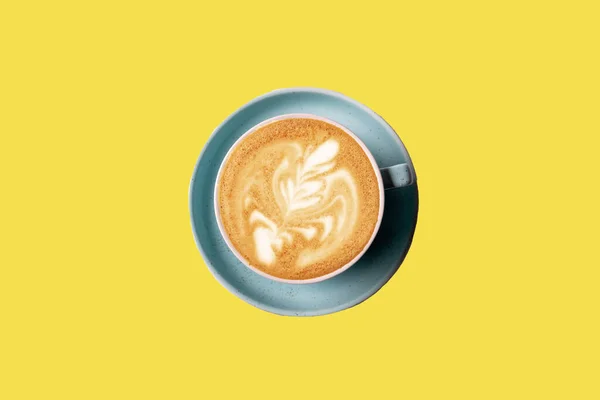 Flat lay latte art coffee with foam in a cup on yellow background, copy space for text,flat lay