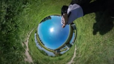 Çim gösterir tarafından onun pazı yeşil çim Köprüsü nehir Reed su turist tarafından aracılığıyla doğa güneşli yaz öğle vaktinde yürüyen 360vr Video adam mavi gökyüzü