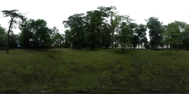 360vr Video Man få av cykel Park gröna träd gränder Man i ljusa gula jacka tar sin kamera bort turist Backpacker i molnig dag — Stockvideo