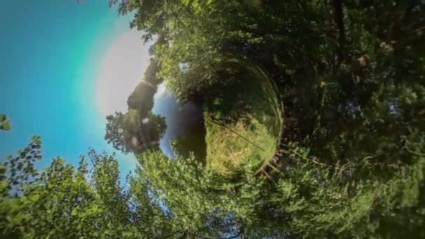 360Vr Vídeo Las personas pasan tiempo cerca del río Caminando por la orilla del lago Los árboles de agua lisa en la otra orilla en un horizonte Pendientes verdes Cielo azul Verano Atardecer — Vídeos de Stock