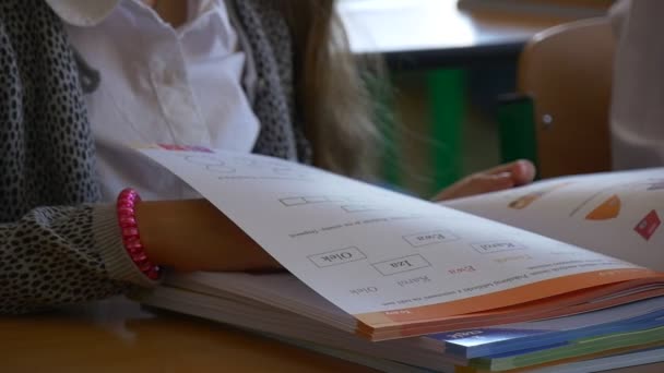 A menina estuda o livro fino — Vídeo de Stock