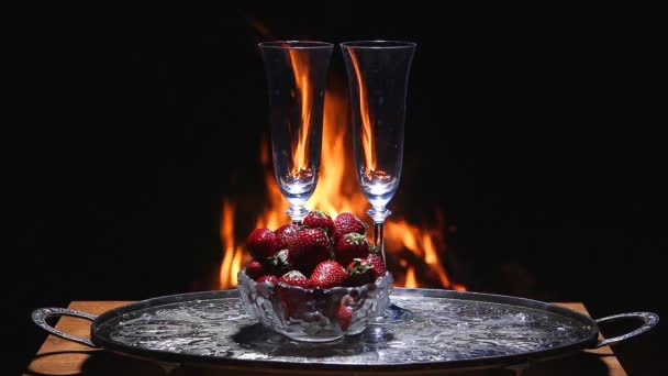 Two glasses of champagne with flame on background — Stock Video