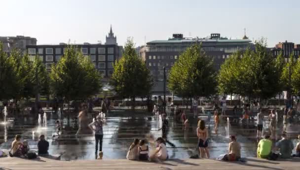 Moscú; Rusia, en un caluroso día de verano la gente disfruta de la frescura del agua de la fuente del ímpetu en el terraplén del río Moscú cerca del Parque Central.. — Vídeo de stock