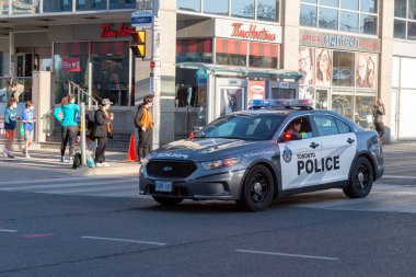 Toronto, ON, Kanada - 24 Ekim 2025: Işıkları açık bir Toronto Polis arabası şehir caddesinde ilerliyor.
