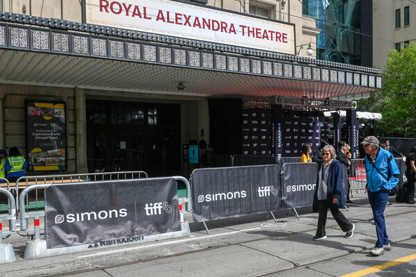 Toronto, ON, Canada - September 7, 2025: Royal Alexandra Theatre marquee and barriers set up for a public event, with people walking by during a film festival