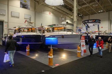 Toronto, ON, Kanada - 20 Ocak 2026: Toronto Uluslararası Boat Show 'da satılık tabelaları olan çok sayıda tekne gösteriliyor, ziyaretçiler deniz araçlarına ve eğlence araçlarına göz atıyor