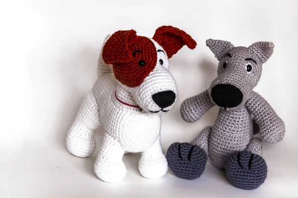 Amigurumi dolls dog, wolf, cat is photographed in the studio.