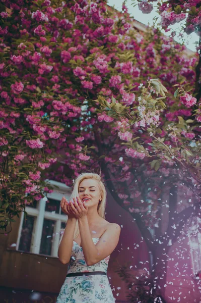 Beautiful blond girl in garden — Stock Photo, Image