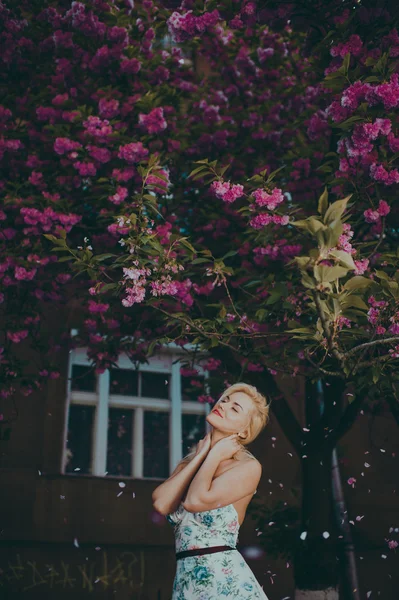 Beautiful blond girl in garden — Stock Photo, Image