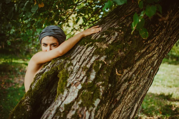 Flicka poserar nära ett träd — Stockfoto