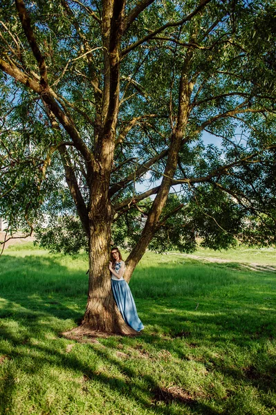 Beautiful girl in a long dress — Stock Photo, Image