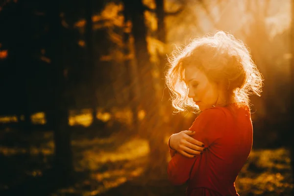 Redhead girl in mysterious forest Stock Photo